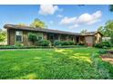 Attractive single-story home featuring a covered porch, lush landscaping, and a spacious well-kept lawn at 3135 Lake Shore S Rd, Denver, NC 28037