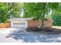 Spacious garage with white door, set in a brick home with triangular window features at 318 W Peeler St, Salisbury, NC 28146
