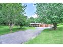 Landscaped front yard with a long driveway leading to a brick home at 4004 Stillwater Ct, York, SC 29745