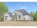 Beautiful two-story home with white siding, a dark roof, and a landscaped front yard at 4032 Brandy Creek Ct, Clover, SC 29710