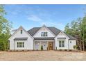 Charming two-story home with white siding, dark roof, and a well-maintained front lawn at 4032 Brandy Creek Ct, Clover, SC 29710