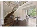 Elegant foyer with a grand curved staircase and gleaming hardwood floors at 426 Kirkbride Ct, Fort Mill, SC 29715