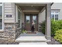 Inviting front porch featuring stone accents, a welcome mat, and a friendly face at 426 Kirkbride Ct, Fort Mill, SC 29715