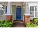 Inviting covered entry with brick accents and a vibrant blue door at 435 Hurston Cir, Charlotte, NC 28208