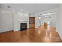 Bright living room featuring hardwood floors, fireplace, and open layout at 435 Hurston Cir, Charlotte, NC 28208
