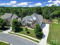 Gorgeous home with lush landscaping, long driveway, beautiful trees and a combination of stone and siding at 510 Placid Ct, Tega Cay, SC 29708