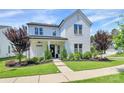 Inviting white brick home with a covered front porch and beautiful landscaping at 5129 Whitman Ave, Matthews, NC 28105