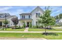 Attractive white home with manicured lawn and landscaping, showcasing its curb appeal at 5129 Whitman Ave, Matthews, NC 28105