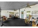 Inviting front porch with ceiling fans, cozy seating, and a charming rocking chair, creating a relaxing outdoor space at 5425 Creek Run Ct, Kings Mountain, NC 28086
