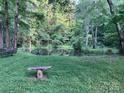 Peaceful pond view featuring a quaint bench overlooking calm water and green surroundings at 5425 Creek Run Ct, Kings Mountain, NC 28086