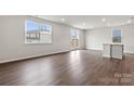 Spacious living room with hardwood floors, a large window, and glass doors to the backyard at 707 Olde England Dr, Lincolnton, NC 28092