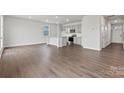 Bright living area with hardwood floors seamlessly connected to an open kitchen and dining space at 707 Olde England Dr, Lincolnton, NC 28092
