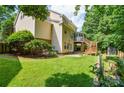 Spacious backyard with a well-maintained lawn, wooden deck, and mature trees at 7321 Harrisonwoods Pl, Charlotte, NC 28270