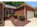 Well-maintained brick home exterior featuring a manicured lawn and inviting front entrance at 8002 Kingston Dr, Waxhaw, NC 28173