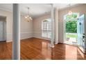 Bright living room with hardwood floors, columns, and large windows at 8002 Kingston Dr, Waxhaw, NC 28173