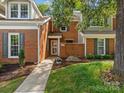 Close up of a lovely red brick house with inviting walkway to front door at 9473 Kings Falls Dr, Charlotte, NC 28210