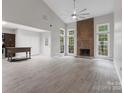 Spacious living room with a vaulted ceiling, fireplace and natural light at 9473 Kings Falls Dr, Charlotte, NC 28210