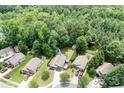 Aerial view of a residential neighborhood with tree coverage at 9716 Psalms St, Cornelius, NC 28031