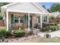 Charming home exterior with rocking chairs on the porch, complemented by lush landscaping at 9716 Psalms St, Cornelius, NC 28031