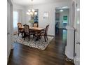 Formal dining room boasts wood floors, decorative rug, chandelier and ample seating at 1019 Beacon Ave, Monroe, NC 28110