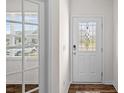 Bright entry featuring a window, wood-look flooring and a decorative front door at 128 Cherry Birch St, Mooresville, NC 28117