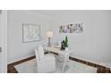 Well-lit home office with white walls, contemporary art, and a modern desk setup with a comfortable chair at 128 Cherry Birch St, Mooresville, NC 28117