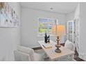 Bright home office with white walls, a large window, and a stylish desk featuring decor and a comfortable chair at 128 Cherry Birch St, Mooresville, NC 28117