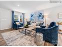 Bright living room featuring stylish blue accents, hardwood floors and modern decor at 1531 River Cane St, Edgemoor, SC 29712