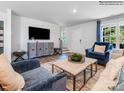 Open-concept living room with a modern entertainment center, hardwood floors, and stylish decor at 1531 River Cane St, Edgemoor, SC 29712