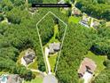 Aerial view showcases the home's lot lines, surrounding lush trees, and prime location at 168 Blue Ridge Trl, Mooresville, NC 28117