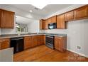 Well-designed kitchen with wood cabinets, stainless steel oven and microwave, offering a practical cooking space at 17513 Hawks View Dr, Fort Mill, SC 29707