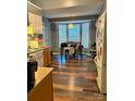 Eat-in kitchen features wood floors, stainless refrigerator, and large window at 1920 Waldeck Ct, Mount Pleasant, NC 28124