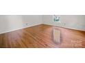 Sunlit bedroom features gleaming hardwood floors and a window offering natural light at 2020 Dawnshire Dr, Gastonia, NC 28054