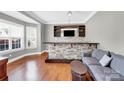 A basement bar area with stone accents, wooden countertop, wine rack, and modern sofa at 2275 Laurens Dr, Concord, NC 28027