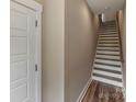 Bright stairway with white risers, wood treads, and plank flooring leading to the next level at 2969 Simpson Dr, Charlotte, NC 28205