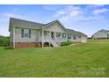 Well-maintained single-Gathering home with light gray siding, a full porch, and a lush green lawn at 308 Laurel Ridge Dr, Lincolnton, NC 28092