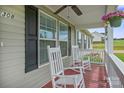Welcoming porch with rocking chairs, plants, and wood flooring at 308 Laurel Ridge Dr, Lincolnton, NC 28092