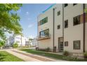 Chic townhome showcasing a private balcony, stylish architecture, and a well-maintained front yard with trees at 327 S Turner Ave, Charlotte, NC 28208