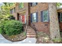 Close-up of a brick home entrance with red door, steps, and wrought iron railings at 3730 Monique Ln, Charlotte, NC 28210