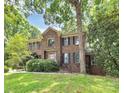 Charming brick two-story home with manicured lawn and lush greenery, enhancing its curb appeal at 3730 Monique Ln, Charlotte, NC 28210
