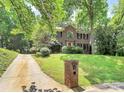 Charming brick two-story home featuring a red front door and a well-maintained lawn at 3730 Monique Ln, Charlotte, NC 28210