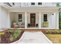 Charming front porch featuring decorative columns and seating area at 416 Plantation Way # 3, Mount Gilead, NC 27306