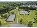 Overhead view of tennis courts surrounded by green space and trees at 4263 Rambling Rose Ln # 23, Rock Hill, SC 29732