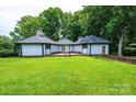 Well-maintained home featuring a lovely lawn, light blue siding, and wooded backdrop at 4275 Herman Sipe Rd, Conover, NC 28613