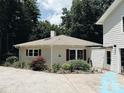 Back of house featuring red shutters, green yard, with the bonus of a garage at 5017 Celeste Ct, Charlotte, NC 27609