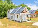 Newly built home with a inviting front porch, complemented by well-maintained landscaping at 512 North Mulberry St, Cherryville, NC 28021