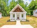 New construction home with a charming covered front porch and well-manicured landscaping at 512 North Mulberry St, Cherryville, NC 28021