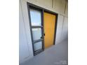 Apartment front door with window sidelight, framed in gray with a yellow door at 514 W 10Th St # 403, Charlotte, NC 28202