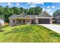 Lovely brick home with a covered front porch and an attached garage, blending charm and practicality seamlessly at 6249 Hayden Dr, Hickory, NC 28601
