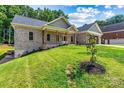 Beautiful brick home featuring a cozy front porch, perfect for enjoying quiet evenings in a serene setting at 6249 Hayden Dr, Hickory, NC 28601